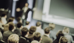 Large Group of People Listening to a Presentation